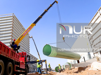 Construction workers are carrying out pipeline hoisting at the construction site of the Zhangye Waste Disposal and Resource Utilization Cent...