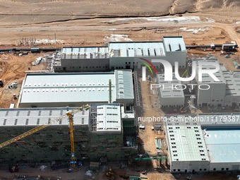 An aerial view is showing the construction project of the Zhangye Hazardous Waste (solid waste) disposal and resource utilization Center in...
