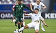 Abdukodir Khusanov (R) of Uzbekistan is battling for the ball with Haitham Mohammed Asiri...