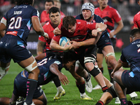 Cullen Grace (C) of the Crusaders is being tackled by the defense of the Rebels during the round ten Super Rugby match between the Crusaders...