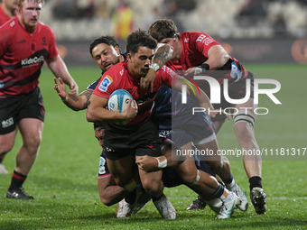 Noah Hotham (C) of the Crusaders is being tackled by the defense of the Rebels during the round ten Super Rugby match between the Crusaders...