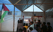 Palestinian children are attending class at a makeshift school in a camp for displaced Pal...