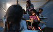 Palestinian children are attending class at a makeshift school in a camp for displaced Pal...