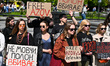 Participants are holding placards at the Taras Shevchenko monument in Lviv, Ukraine, on Ap...