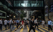 People are crossing the road in the central district of Hong Kong on April 30, 2024. 