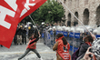 Protesters are scuffling with riot police as they attempt to defy a ban and march on Taksi...