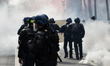 CRS riot police are confronting demonstrators using tear gas during the annual protest mar...