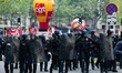 Demonstrators are standing behind the police during the annual protest marking Internation...