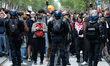 Demonstrators are standing behind the police during the annual protest marking Internation...