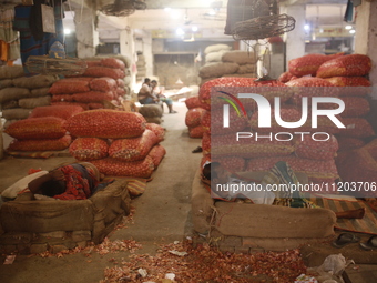 Vendors are sleeping on a hot summer day at a market in Dhaka, Bangladesh, on May 2, 2024. (