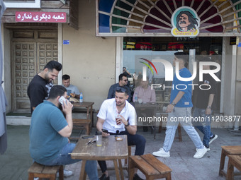 Iranian youths are sitting together at an outdoor cafe in Bushehr, Iran, on April 28, 2024. This city is notable for being Iran's first nucl...