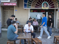 Iranian youths are sitting together at an outdoor cafe in Bushehr, Iran, on April 28, 2024. This city is notable for being Iran's first nucl...