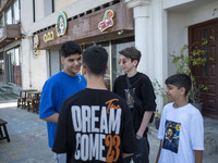 Iranian youths are standing together outside an outdoor cafe in Bushehr, Iran's first nuclear seaport city, located in Bushehr province on t...