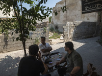 Iranian men are sitting together at an outdoor cafe in Bushehr, Iran, on April 28, 2024. This city is notable for being Iran's first nuclear...