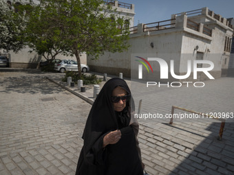 An elderly Iranian woman is walking along a street at a bazaar in Bushehr, Iran, on April 28, 2024. Bushehr is Iran's first nuclear seaport...