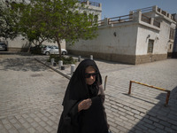 An elderly Iranian woman is walking along a street at a bazaar in Bushehr, Iran, on April 28, 2024. Bushehr is Iran's first nuclear seaport...