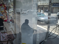 An elderly Iranian man is sitting on a sidewalk near a bazaar in Bushehr, Iran, on April 28, 2024. Bushehr is Iran's first nuclear seaport c...