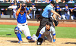 Chicago Cubs' Nick Madrigal #1 is being tagged out by New York Mets catcher Omar Narvaez #...