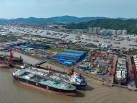 Workers are repairing ships in Zhoushan, China, on May 3, 2024. (
