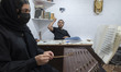 An Iranian music teacher is teaching a young girl how to play the santur at an art institu...