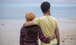 An Iranian couple is standing on a beach in Bushehr, Iran, on April 28, 2024. They are in...