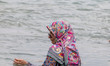 An Iranian woman is standing in water on the northern coast of the Persian Gulf in Bushehr...
