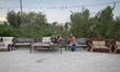 Two Iranian men are sitting at an outdoor cafe near a beach on the northern coast of the P...