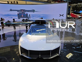 Visitors are watching the Xiaopeng AEROHT Land and Air integrated flying car at the 2024 Beijing International Automotive Exhibition in Beij...