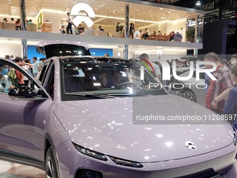 Visitors are looking at NIO electric cars at the 2024 Beijing International Automotive Exhibition in Beijing, China, on May 3, 2024. (