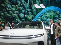 Visitors are looking at Li Auto L6 electric cars at the 2024 Beijing International Automotive Exhibition in Beijing, China, on May 3, 2024....