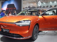 Visitors are looking at an AITO M9 electric car at the 2024 Beijing International Automotive Exhibition in Beijing, China, on May 3, 2024. (
