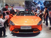 Visitors are looking at the Xiaomi Auto SU7 electric car at the 2024 Beijing International Automotive Exhibition in Beijing, China, on May 3...