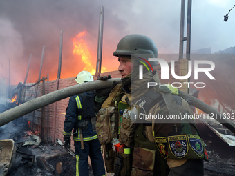 A firefighter is working at the scene of a fire following a Russian missile strike in Kharkiv, northeastern Ukraine, on May 4, 2024. (