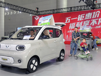 Visitors are viewing the Wuling Auto exhibition area at the 21st Anhui International Automobile Exhibition in Hefei, Anhui Province, China,...
