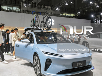 Visitors are exploring the exhibition area of NIO at the 21st Anhui International Automobile Exhibition in Hefei, Anhui Province, China, on...