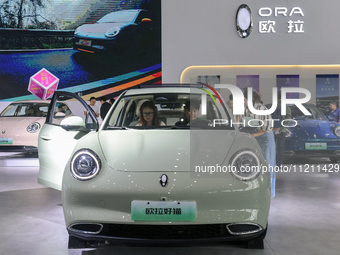 Visitors are viewing the ORA auto exhibition area at the 21st Anhui International Automobile Exhibition in Hefei, Anhui Province, China, on...
