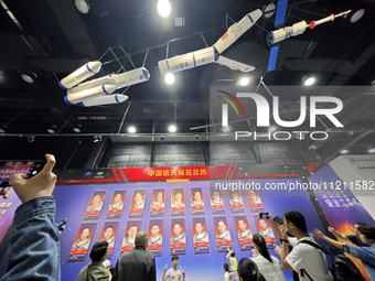 Visitors are taking photos at the signature wall of Chinese astronauts at the China Science and Technology Museum in Beijing, China, on May...