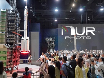 Visitors are watching a demonstration of a Long March 2F rocket launch simulation at the China Science and Technology Museum in Beijing, Chi...