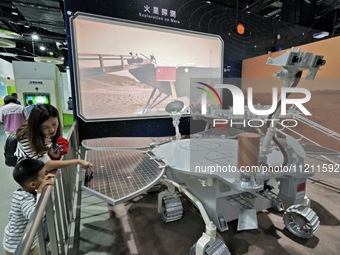 Visitors are learning about the Zhurong rover at the China Science and Technology Museum in Beijing, China, on May 4, 2024. (
