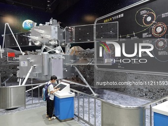 A child is learning about the Chang'e-5 probe at the China Science and Technology Museum in Beijing, China, on May 4, 2024. (
