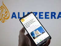 The Al Jazeera website is being displayed on a smartphone with Al Jazeera visible in the background in this photo illustration, taken in Bru...