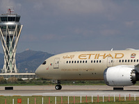 A Boeing 787-9 Dreamliner operated by Etihad Airways is preparing to take off on the runway at Barcelona-El Prat Airport in Barcelona, Spain...
