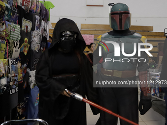 A Star Wars fan is posing as The Mandalorian at the Reto Fest CDMX convention to celebrate World Star Wars Day at the Churubusco Convention...