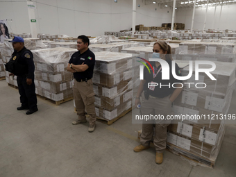 Electoral officials are guarding the electoral packages that will be used for the 2024 elections in Mexico during a press conference marking...