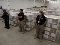Electoral officials are guarding the electoral packages that will be used for the 2024 elections in Mexico during a press conference marking...