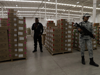 A military guard is watching over the electoral packages that will be used for the 2024 elections in Mexico during a press conference markin...