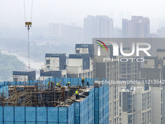 Construction is underway at the Mixc City real estate site in the commercial center of Huai'an City, Jiangsu Province, China, on May 6, 2024...