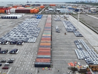 New energy vehicles are being loaded into containers for export at Taicang Port and Taicang International Terminal in Suzhou, Jiangsu Provin...