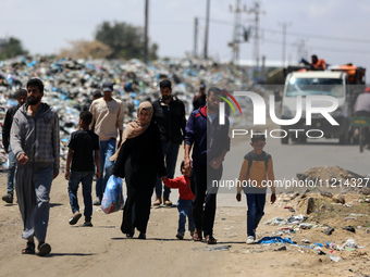 Displaced Palestinians are arriving in Khan Yunis with their belongings from Rafah in the southern Gaza Strip on May 6, 2024, following an e...