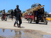 Displaced Palestinians are arriving in Khan Yunis with their belongings from Rafah in the southern Gaza Strip on May 6, 2024, following an e...
